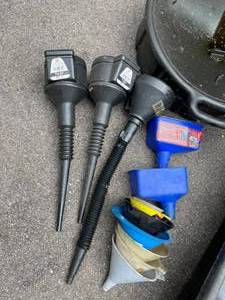 lot 585 image: Large Lot of Metal and Plastic Oil Drain Pans and Funnels