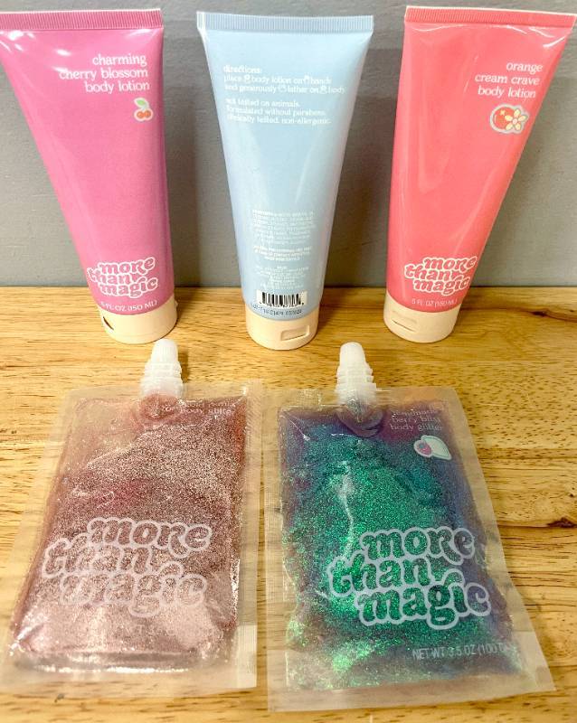 lot 88 image: Lot of 3 Scented Body Lotions and 2 Body Glitter Pouches.  Various scents Unused. 