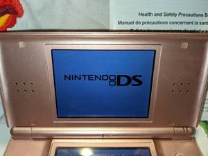 lot 49 image: Nintendo DS Lite Coral Pink Console, Charger, 10 Games