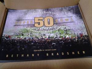lot 99 image: (2) 10ct.Ea. Super Bowl 50 Soft Cover Memorabilia Book Retail $29.99Book