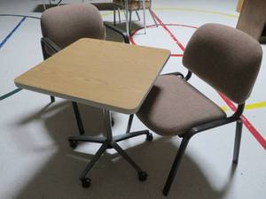 lot 131 image: Rolling woodmetal table with two maroon chairs