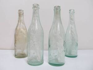 lot 57 image: Lot of 4 Antique Embossed Pre-Prohibition Beer Bottles