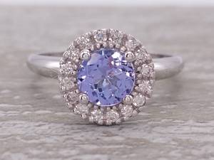 lot 23 image: New Martini Style Natural Tanzanite and Diamond Halo Ring in 14k Gold