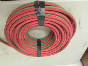 lot 129 image: roll of green and red rubber hose ...
