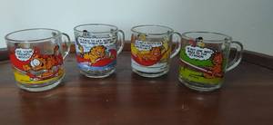 lot 32 image: Four Garfield Glass Mugs