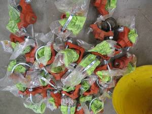 lot 79 image: BUCKET OF NEW CAST IRON WATER LINE TAPS PLUS