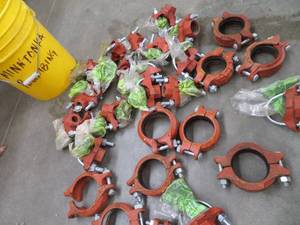 lot 82 image: BUCKET OF  CAST IRON WATER LINE TAPS PLUS COUPLERS