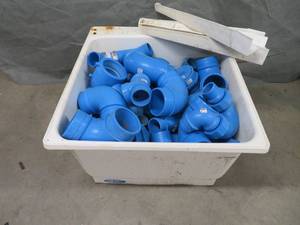 lot 92 image: PLASTIC UTILITY TUB FULL OF BLUE PVC PIPE FITTINGS.