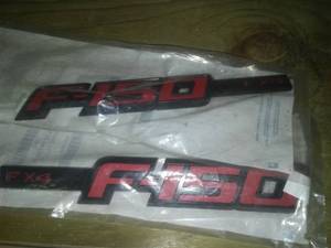 lot 135 image: GENUINE FORD RED FX4 EMBLEM-RIGHT, CL3Z-16720-B (2016-2020 F150 Trucks)