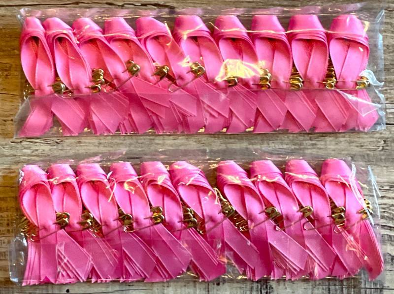 lot 33 image: Lot of 500 Pink Cancer Ribbons with Gold Safety Pins. 