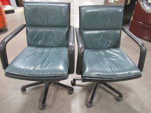 lot 75 image: Set of 2 Green and Black Faux Leather Office Chairs - May have Small TearsScuffs.