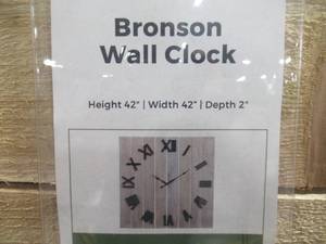 lot 655 image: Signature Design by Ashley Bronson Wall Clock A8010179