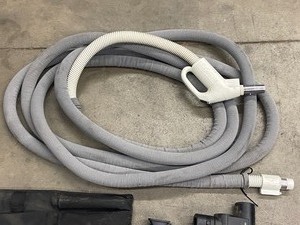 lot 18-A image: NuTone Central Vac Hose With New-Style Plug, Includes Bag Of Vac Accessories