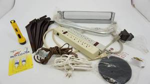 lot 76 image: Two Power Strips-Two Extension Cords-Faultless HOT Iron Cleaner-Metal Tray-Twelve Shelf Brackets-Ace Flashlight-Compost Keeper Replacement Filter-Knob ForOn Top Of A Railing