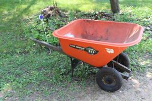 lot 818 image: True Temper Big 10 cu.ft. Plastic Wheelbarrow with Rubber Wheels and Wood Handles