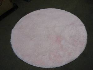 lot 229 image: Pink Fuzzy Rug with 5 foot Diameter...