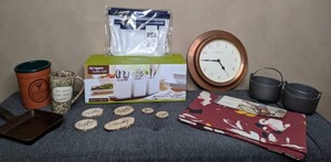 lot 349 image: Mixed Lot of Home Dcor Copper Smith & Hawkins Wall Clock, New Threshold Table Runner, New Pier 1 Imports Flatware Caddy Set, & More