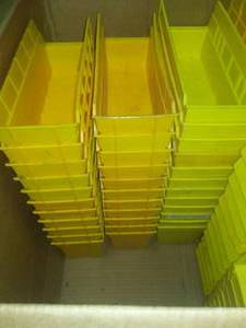 About 80 plastic parts bins.