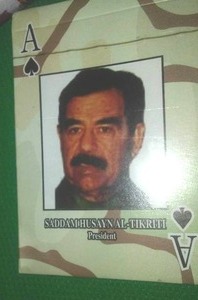 Clock, Saddam Hussain playing cards and bags.