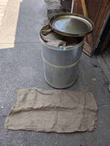 lot 87 image: Metal Drum Full of Burlap Sacks