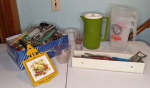 lot 463 image: Vintage Kitchen Lot - Yellow Cast Iron Trivet, Handtools and Pitchers