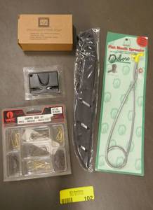 lot 102 image: Filet knife, mouth spreader, crappie hooks, knife sharpener, stainless steel soap