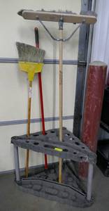 lot 119 image: Corner storage organizer unit with a couple of brooms and handle