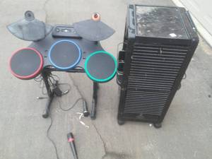 lot 52 image: Locking Cabinet  Guitar Hero Microphones and drum set