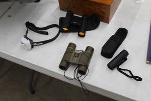 lot 36 image: Lot of (4) Sporting Goods  - 8x20mm Golf Range Finder, Bushnell Binoculars, 10x25DCF 100M1000M Binoculars, LuxoLite Headlamp