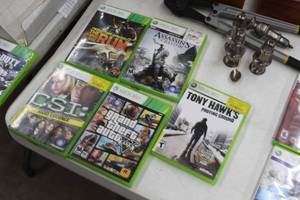 lot 126 image: Lot of (5) Xbox 360 Video Games  - Need For Speed The Run, Tony Hawks Proving Grounds, GTA V, CSI Hard Evidence, Assassins Creed III