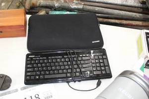 lot 114 image: Lot of (2) Computer Accessories  - MSI StarType E5500 Wired Computer Keyboard, Incase Soft-side LaptopTablet Carry Case