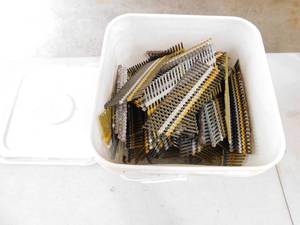 A Plastic Container W  Steel Nails That Fit In A Nail Gun