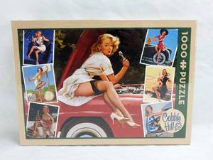 lot 44 image: Cobble Hill Gil Elvgren Roadside Attractions Pin Up 1000 Piece Sealed Puzzle