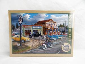 lot 50 image: Cobble Hill Ken Zylla Crossroads 1000 Piece Sealed Puzzle