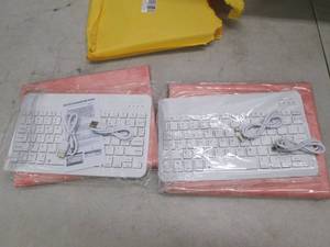 lot 26 image: 2 pink cases with bluetooth keyboar...