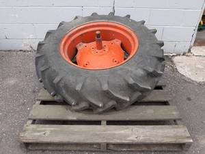 lot 374 image: Armstrong 12.4  11-24 Tractor Tire on Rim - Good Shape