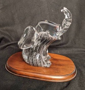 lot 12 image: Adorable Glass Baby Elephant on Wood Platform from Sweden
