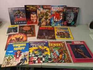 lot 440 image: Mixed Lot of Natural Geographic Magazines, Game Manuals, The Elders Revenge Playbook, Marvel Avengers & More