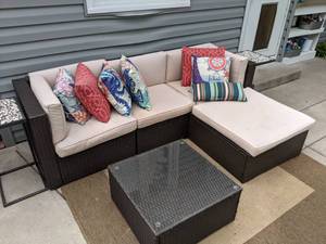 lot 531 image: Stunning Plastic Wicker Patio Couch, All-Weather Rug, Glass-Top Coffee Table, Two End Tables, and Cushions