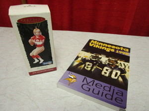 lot 462 image: MN VIKINGS 1998 MEDIA GUIDE SIGNED BY JAKE REED, CHRIS CARTER, HALLMARK JOE MONTANA ORNAMENT