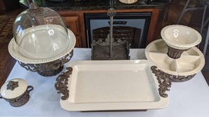 lot 29 image: GG Collection Gracious Goods Cream Ceramic Crudit Set with Metal Holder, Cream Rectangular Tray with Metal Handles, Cake Pedestal with Dome & Plate, & More