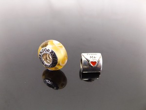 lot 60 image: 2 PANDORA ALE .925 Sterling Silver Beads #790894EN09 and #790645