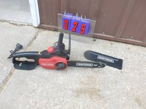 lot 25 image: Craftsman 110 volt chainsaw. Lightly used. Tested & works. As shown.