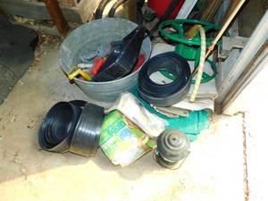 lot 36 image: Garden Hose Reel--Metal Bucket Filled With Miscellaneous Items--Lawn & Garden Edging--Kerosene Lantern
