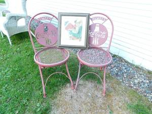 lot 88 image: Two Pink Metal Icon Patio Chairs--(Always Coca-Cola)--Framed Picture Of Santa Sitting On Chair Drinking A Bottle Of Coca Cola