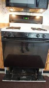 lot 107 image: Four Burner Gas Stove--Broiler On Bottom In Drawer Below Oven--Oven W Two Racks--Glass Window In Oven Drawer--Wooden Three Shelf Towel Rack Or Spice Rack