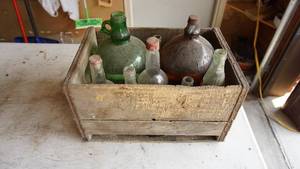 Old Wooden Crate Filled With Nine Glass Containers