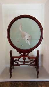 Kitten Watching A Creature On A Picture Connected To Decorative Stand