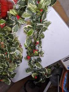 lot 135 image: Christmas Decor - Festive Holly Leaf Garland & Two Pails of Pine Cones