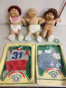 lot 49 image: Three Cabbage Patch Dolls and Two Outfits